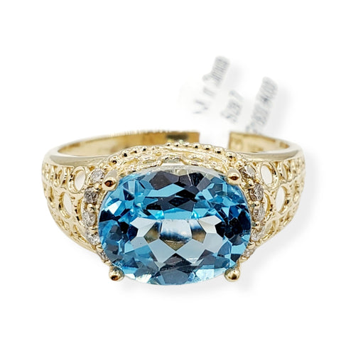 14kt yellow gold ring with one prong set oval cut natural blue topaz and diamonds (0.15cts)